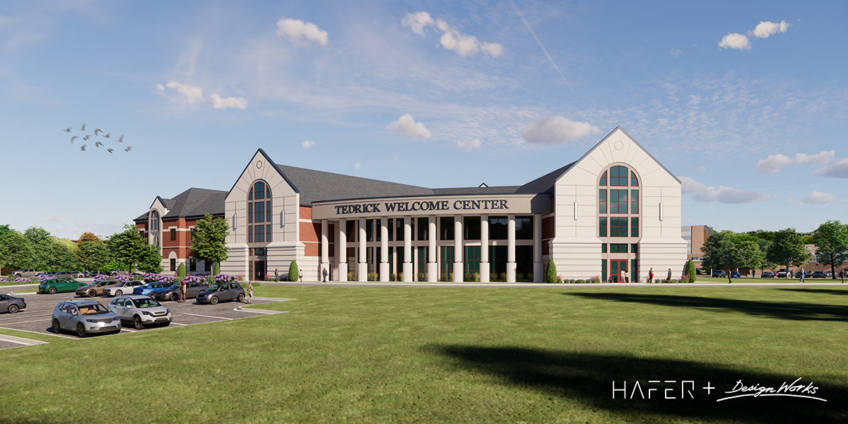 The architectural design of the Tedrick Welcome Center showcases large white pillars, arched windows, and red brick accents.